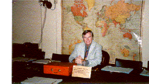 The author enjoys the seat of power in the War Rooms. The red, wooden box carried dispatches to/from the King.